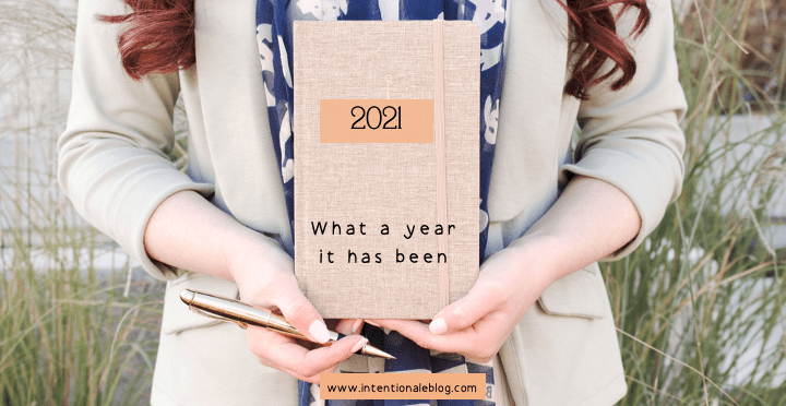 notebook held by 2 hands with text: 2021  What a year it has been 