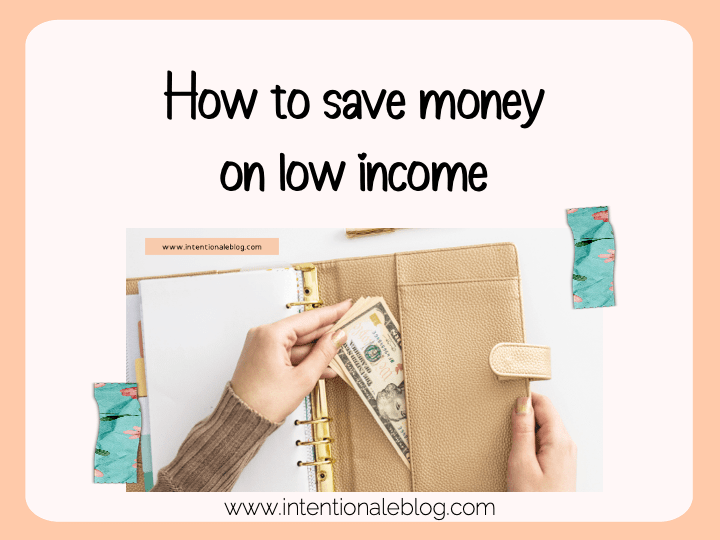 image with text How to save money on low income with a photo of a hand putting money in a planner