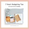 image of a wooden board with pink calculator on top and money, a big white journal and a smaller beige notebook