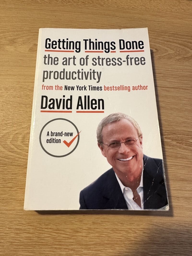 image of a book with a title getting things done method with an image of david allen