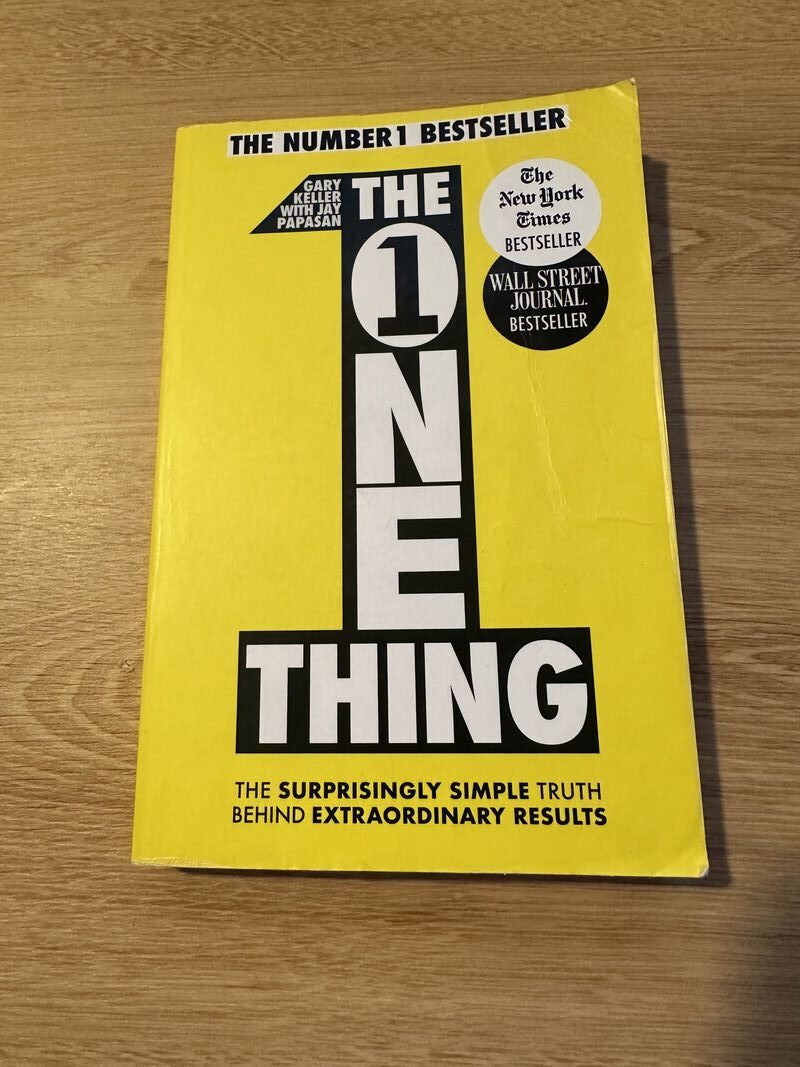 image of a book with a title the one thing, yellow cover and black text 