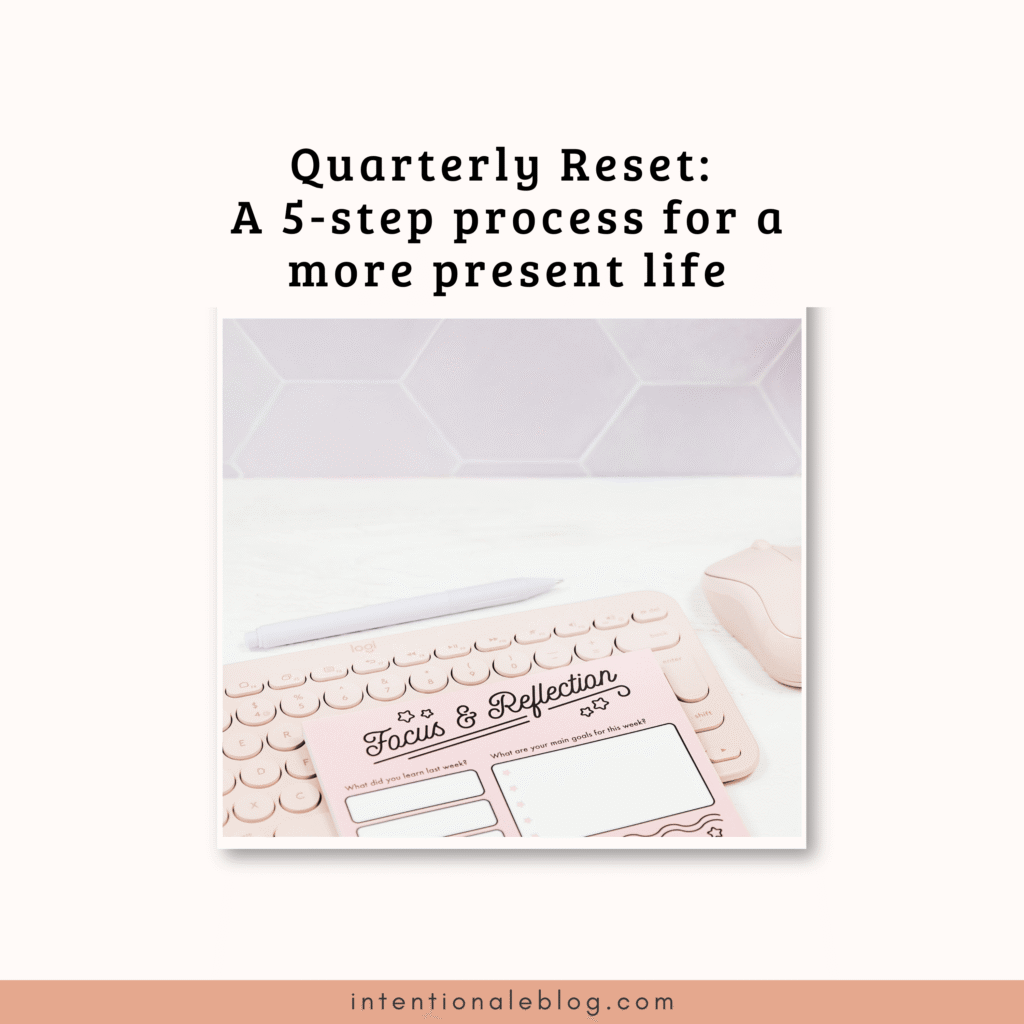 A pink notepad labeled Focus & Reflection sits on a desk with a pen and mouse, under the title Quarterly Reset: A 90-day planner for a more present life.
